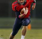 Heritage's Will Knapke picks up steam as he runs the football in the Patriots' game against Garrett on Friday at Heritage. Photo by Chad Ryan