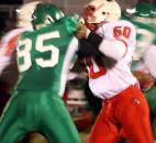 North Side’s Tycel Haynes, right, blocks South Side’s Nolan Thomas on a running play Friday at South Side. North beat South 26-22 in a Class 5A Sectional 3 semifinal game. (By Don Converset of The News-Sentinel)