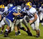 Homestead junior Zach Swarts battles Carroll sophomore Connor Burgess on the line of scrimmage Friday night. (By Blake Sebring of The News-Sentinel)