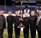 Homestead drum majors, from left next to ISSMA President Mark Middleton, Jeremy Tatara, Anna Tatara, McKenna Fitzharris and Samantha Schacht accept the Class A state runner-up trophy Saturday in Indianapolis. At right is a representative of the American Dairy Association, a sponsor of ISSMA events. Photo by Garth Snow
