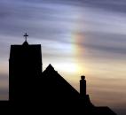 A rainbow forms in the morning clouds as seen behind St. Mary's Catholic Church in Alton, Ill., early Tuesday. The leading edge of superstorm Sandy reached the eastern part of the St. Louis metropolitan area Tuesday morning. Photo by John Badman