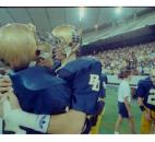 Members of Bishop Dwenger's football team embrace in celebration after beating New Palestine 56-14 in the 1990 Class 3A state finals at the Hoosier Dome in Indianapolis. This would be the first of three state championships in the 1990s for the Saints and their first undefeated season in program history. In addition, Bishop Dwenger's 56 points against New Palestine remains the IHSAA record for most points scored in a Class 3A state finals game. (News-Sentinel file photo)