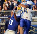 Carroll’s Stallone Yovanovitch keeps East Noble’s Lake Clark from making a catch during the first quarter of play Friday night at Carroll HIgh School. Carroll won, 24-20. (By Ellie Bogue of The News-Sentinel)