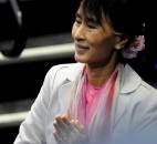 Aung San Suu Kyi gives one last smile before leaving the arena Tuesday morning. By Ellie Bogue 