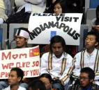 Students from Perry Meridian High School in Indianapolis hold signs encouraging world leader Aung San Suu Kyi to drop by their city. About 150 Burmese students from the school traveled to Fort Wayne to hear her speak. By Ellie Bogue 