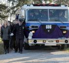 Members of the Washington Township Fire Department walk next to a Washington Township Fire truck, which bore the body of fallen Washington Township Fire Fighter Mark A. Haudenschild II Saturday afternoon as he was laid to rest in the Riverview Cemetery, &quot;&quot;425 Carroll Road. Photo by Ellie Bogue