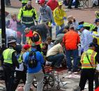 Medical workers aid injured people at the 2013 Boston Marathon after an explosion in Boston. Photo by By The Associated Press