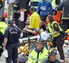 Rescue personnel aid injured people near the finish line of the 2013 Boston Marathon after explosions in Boston. Photo by By The Associated Press