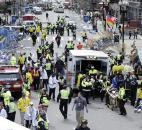 Medical workers aid injured people at the finish line of the 2013 Boston Marathon after an explosion in Boston. Photo by By The Associated Press