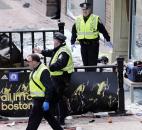 Boston police clear an area after an explosion near the finish line of the 2013 Boston Marathon in Boston. Photo by By The Associated Press