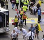 Medical workers aid injured people at the finish line of the 2013 Boston Marathon after an explosion in Boston. Photo by By The Associated Press
