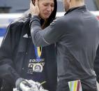 An unidentified Boston Marathon runner is comforted as she cries in the aftermath of two blasts near the finish line of the Boston Marathon in Boston. Photo by By The Associated Press