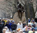 Runners who were diverted from the race course walk on the Commonwealth Mall two blocks from the site of an explosion at the finish line of the Boston Marathon on Monday in Boston. Photo by By The Associated Press