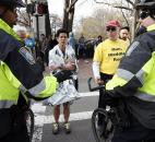 Boston police direct runners who were diverted from the race course after an explosion at the finish line of the Boston Marathon in Boston. Photo by By The Associated Press