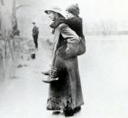 An unidentified rescuer carried a child to higher ground. (Photo courtesy of The History Center)