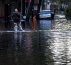 David Bagatelle, of Hoboken, N.J., walks from his residence on Park Avenue through high water in Hoboken, N.J., this morning, in the wake of superstorm Sandy. Bagatelle's home is surrounded by water, but dry, where his wife and seven day old baby are staying. Photo by Craig Ruttle