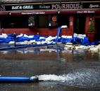 Water is pumped from a restaurant on First Street in Hoboken, N.J., this morning, in the wake of superstorm Sandy. Parts of the city are still covered in standing water, trapping some residents in their homes. Photo by Craig Ruttle