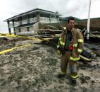 Firefighter Ben Sisti of Goodwill Fire Co. #2 stands amidst rubble where the boardwalk and the Spring Lake pavilion were destroyed by Sandy, Tuesday,  in Point Pleasant, N.J. Photo by Kevin R. Wexler
