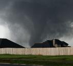 A tornado moves past homes in Moore, Okla., on Monday. (Photo by The Associated Press)