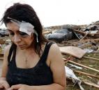 Cindy Wilson texts to friends after her home was destroyed in the Monday afternoon tornado. Cindy and her husband, Staff Sgt. B. Wilson, took cover in their home's bathtub when the tornado hit. Cindy received a deep gash to her forehead, and her wound  was treated by first responders at the scene. The tornado caused extensive damage in Moore, Okla. (Photo by The Associated Press)