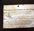 A laundry ticket with a list of services, including darning socks, informs Hotel Indiana guests of what's available.