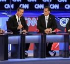 Republican presidential candidates, from left, Ron Paul, Rick Santorum, Mitt Romney and Newt Gingrich share the stage in February during a Republican presidential debate in Mesa, Ariz. After a long, bitter primary campaign, Romney emerged as his party's nominee to take on Barack Obama for the presidency. Photo by The Associated Press