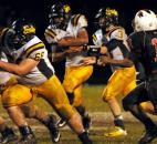 In the third quarter Snider quarterback Brandon Phelps hands off the ball to Jibri Bramley, as the line blocks the North Side Defense Friday night at North Side. Snider beat North Side 17-6. (By Ellie Bogue of The News-Sentinel)