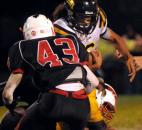 In the fourth quarter Nicolas Reese works through traffic against North Side’s Josh Fleming to get a few yards. Snider beat North Side 17-6. (By Ellie Bogue of The News-Sentinel)