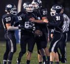 Garrett’s Kyle Lanning gets congratulated by his teammates after running an 85 yard return for a touchdown Friday night at when Leo took on Garrett. (By Ellie Bogue of The News-Sentinel)