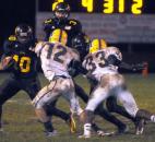 Snider’s Je’Norie Smith runs the ball in the second quarter as Homestead’s Cody Messal and Caleb Hackley apply pressure.Snider beat Homestead Friday night 30-20. (By Ellie Bogue of The News-Sentinel)